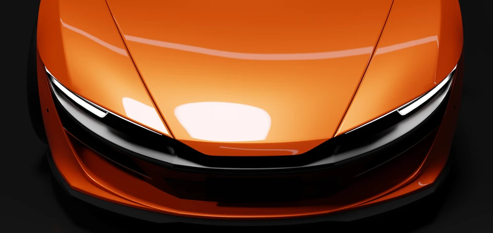 Gros plan sur le capot avant d'une voiture de sport orange métallisé avec reflets lumineux